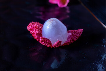 Purified ripe lychee. Open pink lychee peel, colorless translucent fruit pulp. Low Key. Litchi...