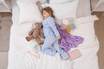 Sleeping little girl dreaming of super powers in bed