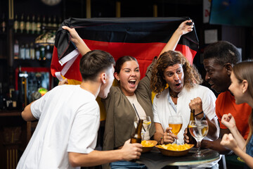 Enthusiastic German fans scream with joy in a beer bar. Germany victory