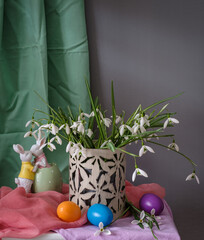 A still life arrangement of Easter eggs, spring flowers. Still life with snowdrops and ester eags.