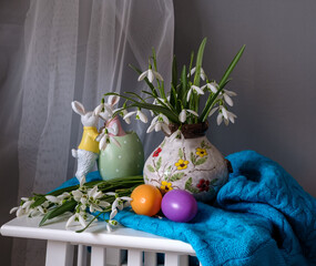 A still life arrangement of Easter eggs, spring flowers. Still life with snowdrops and ester eags. - 764364352
