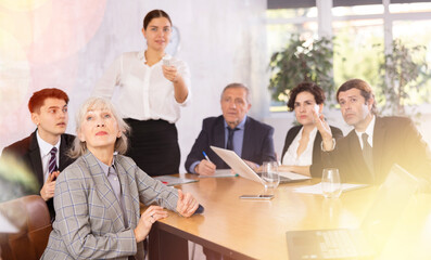 Group of diverse business people attending meeting in conference room, discussing work plan