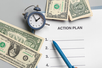 Composition with action plan, alarm clock and money on grey background. Time management concept. Closeup