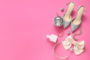 Female shoes with prom tiara, disco balls and accessories on pink background
