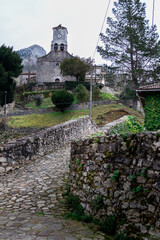 Fototapeta na wymiar Idyllic Cabrales setting stone bridge chapel, unspoiled nature ideal for adventurous rural vacations