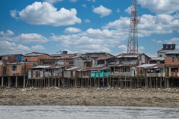 Fototapeta na wymiar Choco, Quibdo, Colombia. March 4, 2020: Houses in the shore of the Atrato River with blue sky. 
