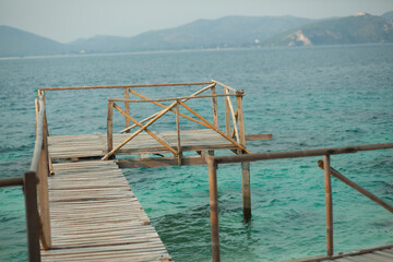 Wooden deck on ocean green water