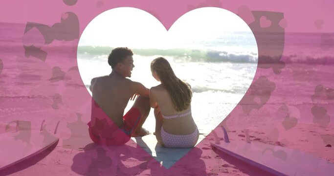 Animation of heart cut out over diverse couple in love on beach in summer