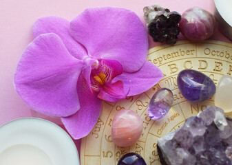 Amethyst crystals, rose quartz and orchid flower. Healing crystals, the magic of precious stones.