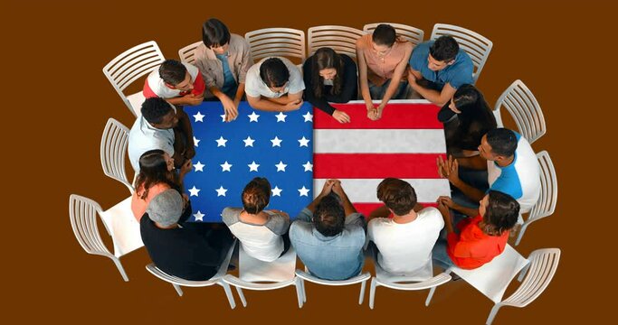 Animation of flag of usa over table and happy diverse business people