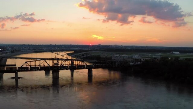 Aerial Scenic View Of Famous Truss Bridge Over River, Drone Flying Backwards During Sunset - Buckner, California