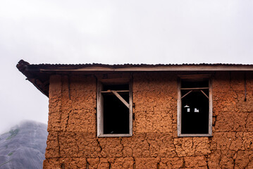 Window and roof of A tradional mud home in Ekiti, West of Nigeria on August 16, 2023. - Powered by Adobe