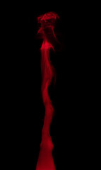 Abstract background of chaotically mixing puffs of red smoke on a dark background