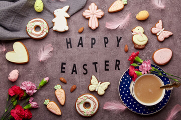Spring aesthetic background with text Happy Easter. Stylish spring Easter cookies, pink flowers, coffee cup and eggs flat lay