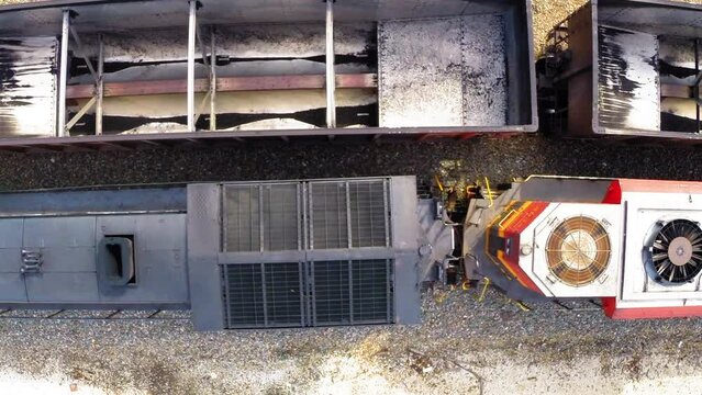 Aerial: Drone Top Upward Shot Of Vehicle Moving By Machinery In Agricultural Field - Buckner, California