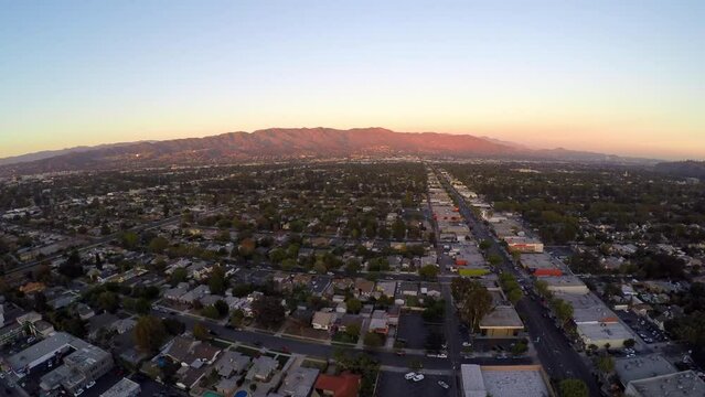 Aerial Panning Scenic View Of Houses By Mountains In City Against Clear Sky During Sunset - Burbank, California