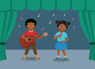 Naklejka premium Cute little African kids singing and playing guitar performing on the stage