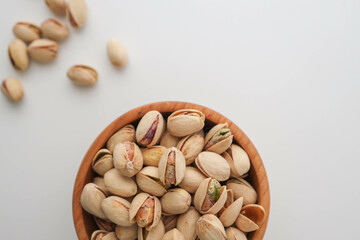 Roasted and salted pistachios in shell on white background
