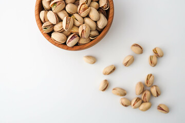 Roasted and salted pistachios in shell on white background
