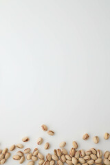 Roasted and salted pistachios in shell on white background