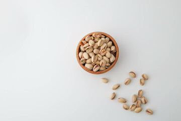 Roasted and salted pistachios in shell on white background