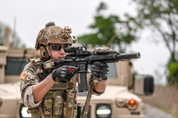 Confident soldier in full gear stands before a military vehicle, rifle in hand, showcasing...