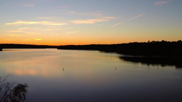 Aerial: Drone Panning Idyllic View Of Tranquil Rippled River During Sunset - Buckner, California