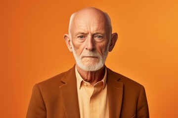 Portrait of an old man with a beard on a orange background - obrazy, fototapety, plakaty