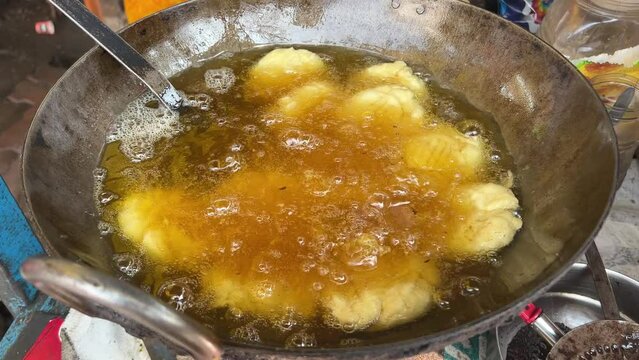 Traditional Thekua being fried in hot oil in local dhaba in Bihari Style.