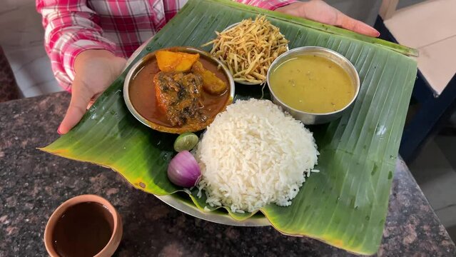 Indian Fish Platter or thali - Popular sea food, Non vegetarian meal from Bengal served in a steel plate or over banana leaf