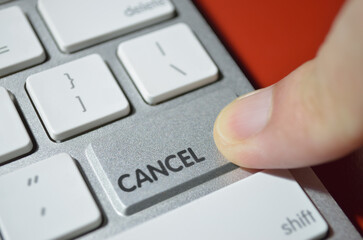 Can't cancel, illustrated by depicting the cancel key as a non-functional bump on aluminum keyboard...