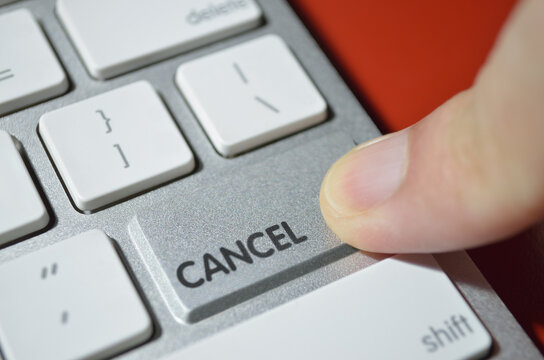 Can't cancel, illustrated by depicting the cancel key as a non-functional bump on aluminum keyboard surface which can't be pressed down