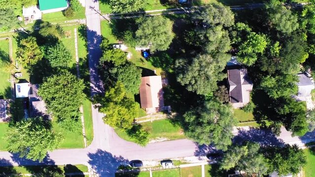 Aerial: Drone Top Upward Shot Of Roofed Houses Amidst Green Trees On Landscape During Sunny Day - Buckner, California