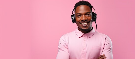 A happy man is wearing headphones and smiling while enjoying music