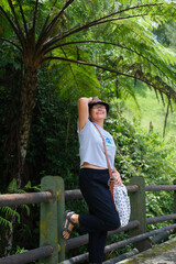 Woman taking a break under forest fern, during morning walk © Simon