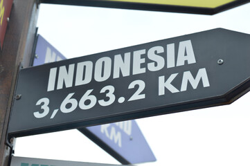 Close-up shots of directional signs pointing towards the enchanting destinations of the Indonesia