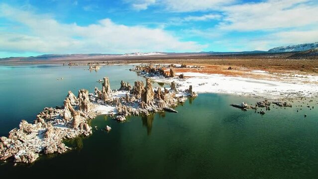 Aerial: Scenic View Of Tranquil Mono Lake, Drone Flying Forward Over Natural Rocks On Sunny Day - June Lake, California