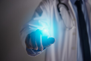 Doctor Hand and Finger Touch Screen and Blue Flare Light. Medical Technology,Innovation,Science and Healthcare Concept