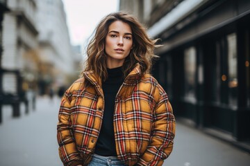 Fototapeta premium A plaid puffer jacket worn over a sweater and jeans for a cozy and on-trend winter look. Woman fashion christmas.