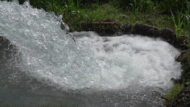 water raised and channeled to irrigate rice fields. The technique of pumping water from the river to flow into the rice fields. Diesel engine compressor super slow motion 240fps