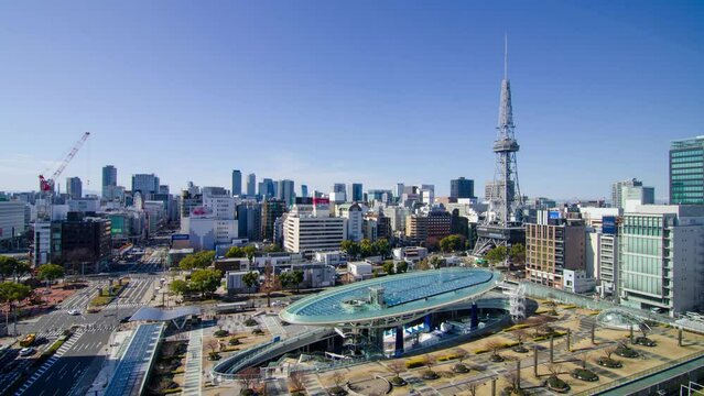 aerial city skyline timelapse view of the Nagoya city center with Nagoya TV Tower landmark building among highrise building and some traffic on street