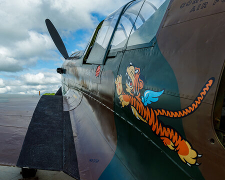left side of P-40 fighter with flying tigers logo visible