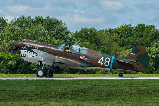 P-40 taxis out in preperation for takeoff with trees in the background
