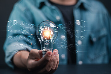AI technology concept. Science and artificial intelligence technology, Big data network connection by use artificial intelligence technology. Businessman holding light bulb with AI tools icon.
