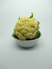 fresh raw cauliflower in a white bowl