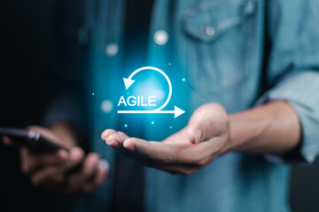 Agile development methodology concept. Businessman holding Agile icon on virtual screen. Iterative...