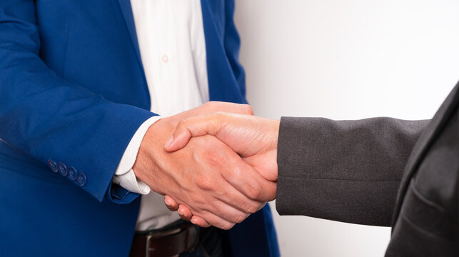 Holding hands with business partners to trust business partners, relationships to achieve future commercial and investment goals.	
