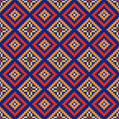 A cross stitch pattern a colorful ethnic patterns of diamonds and triangles on a dark blue background.Design for fabric,pattern,embroidery,pixel,motif,towel,folk,retro,handicraft,abstract,batik,zigzag