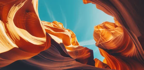 Fototapeten anamorphic shot of antelope canyon, rock formations in the shape of waves and hearts, warm colors, blue sky © Kien