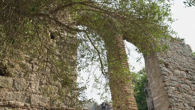 Ruins of Great Basilica in Butrint National Park, Buthrotum, Albania. Triconch Palace at Butrint Life and death of an ancient Roman house Historical medieval Venetian Tower surrounded. Butrint